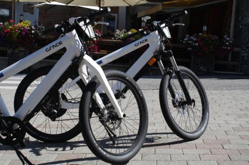 two bikes parked next to each other on a sidewalk at Ruhige Wohnung In Sankt Gallenkirch Mit Garten in Sankt Gallenkirch