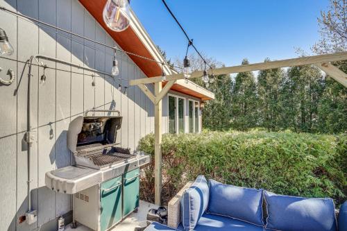 a grill on the side of a house with a couch at 9 Mi to Shore Home with Hot Tub in Howards Grove! in Howards Grove