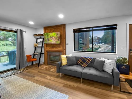 a living room with a couch and a window at Park City Gem at Red Pine! Cozy Ski Condo with Heated Pools and Hot Tubs! B4 by SkyRun Park City in Park City