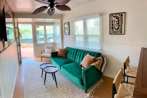 a living room with a green couch and a table at Casa Luna in San Diego
