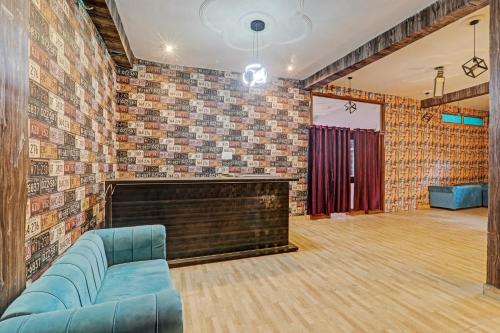 a living room with a couch and a brick wall at Hotel O ONCE MORE RESTAURANT AND CAFE in Prayagraj