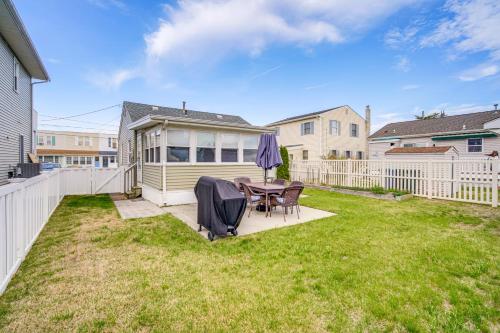 a patio with a table and chairs in a yard at 1 Block to Brigantine Beach Breezy Home with Patio! in Brigantine