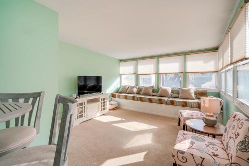 a living room with a couch and a tv at 1 Block to Brigantine Beach Breezy Home with Patio! in Brigantine