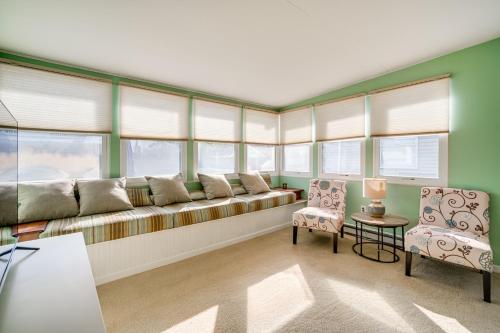 a living room with a long couch and two chairs at 1 Block to Brigantine Beach Breezy Home with Patio! in Brigantine
