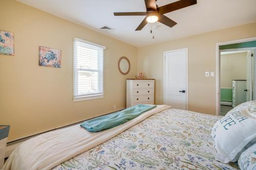 a bedroom with a bed and a ceiling fan at 1 Block to Brigantine Beach Breezy Home with Patio! in Brigantine