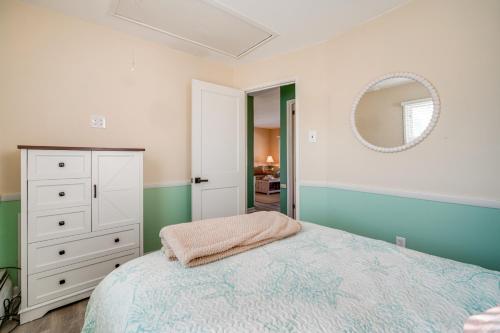 a bedroom with a bed and a mirror at 1 Block to Brigantine Beach Breezy Home with Patio! in Brigantine