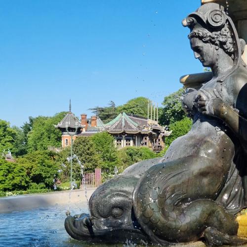 a statue of a mermaid sitting in a fountain at Chinese Pavilion Park - Magnificent Apartment Brussels in Brussels