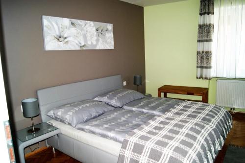 a bedroom with a bed and a picture on the wall at Ferienwohnung In Der Nähe Von Wien in Sankt Andrä vor dem Hagenthale