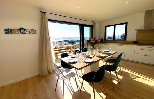 une salle à manger avec une table et des chaises dans une cuisine dans l'établissement Villa Bleu Horizon, à Carantec