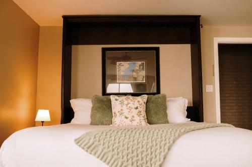 a bedroom with a large bed with a large headboard at Albert's in Shelburne