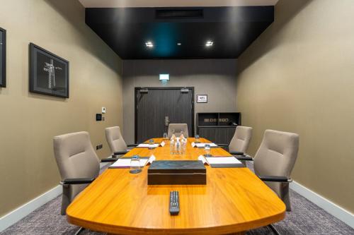 a conference room with a large wooden table and chairs at Crowne Plaza Aberdeen Airport by IHG in Dyce
