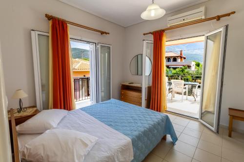 a bedroom with a bed and a balcony at Apartments Thekla in Karavádhos