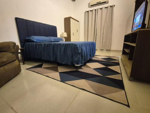 a bedroom with a bed and a television in a room at A beautiful apartment in Caña de Castilla