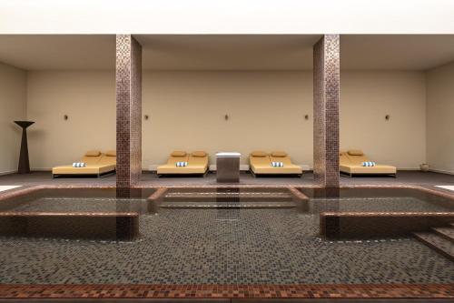 a row of beds in a large room at Kimpton Atlantico Algarve by IHG in Albufeira