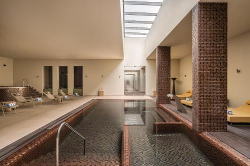 a pool in the middle of a building at Kimpton Atlantico Algarve by IHG in Albufeira