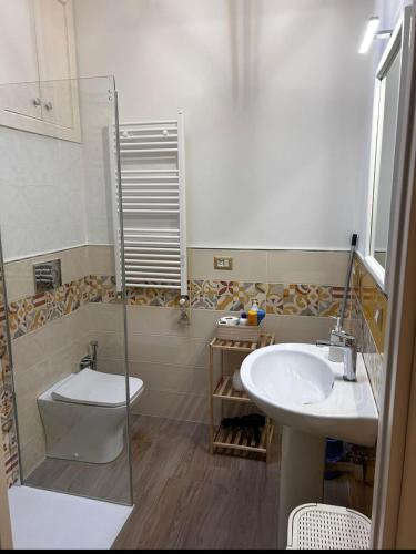 a bathroom with a toilet and a sink at Casaparrinello Maletto Concy in Maletto