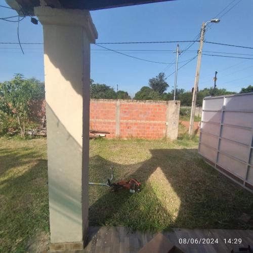 a dog laying on the grass in a yard at Chalet ULI in Luque