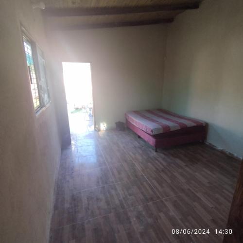 a bedroom with a bed in the corner of a room at Chalet ULI in Luque