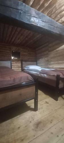 two beds sitting next to each other in a room at Hotel Front Castle in Shatili