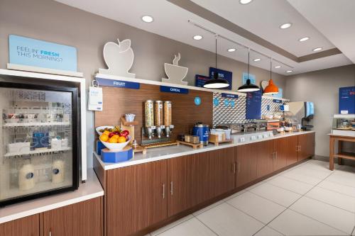 a kitchen with a counter in a store at Holiday Inn Express & Suites Boynton Beach West by IHG in Boynton Beach