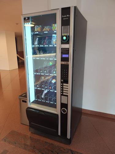 a microwave refrigerator with food inside of it at VBloku Apartments in Prague