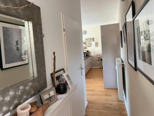 a hallway with white walls and a mirror on the wall at Ferienwohnung Reeker in Kiefersfelden