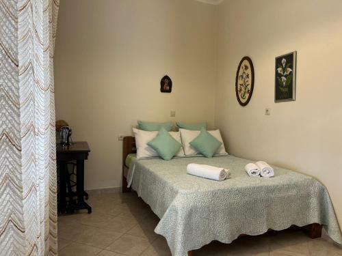 a bedroom with a bed with two towels on it at Drymonas cottage in Kythira