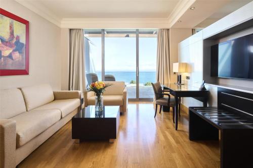 a living room with a couch and a table at Kempinski Hotel Adriatic Istria Croatia in Savudrija