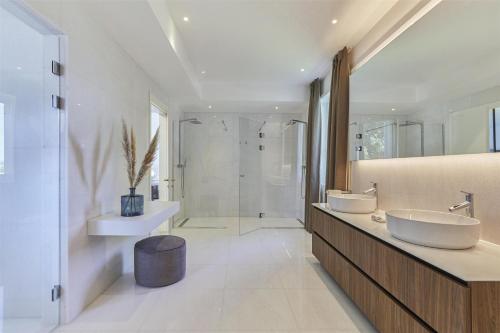 a bathroom with two sinks and a shower at Kempinski Hotel Adriatic Istria Croatia in Savudrija