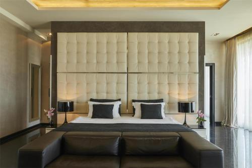 a bedroom with a large bed with a large headboard at Kempinski Hotel Adriatic Istria Croatia in Savudrija