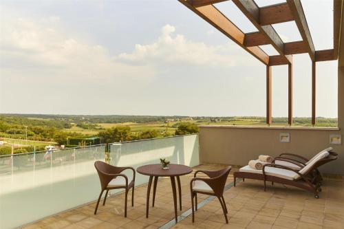 a patio with a table and chairs on a balcony at Kempinski Hotel Adriatic Istria Croatia in Savudrija