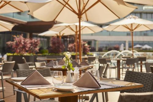 a restaurant with tables and chairs with umbrellas at Kempinski Hotel Adriatic Istria Croatia in Savudrija