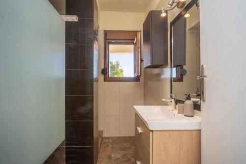 a bathroom with a sink and a shower at Petra in Afitos