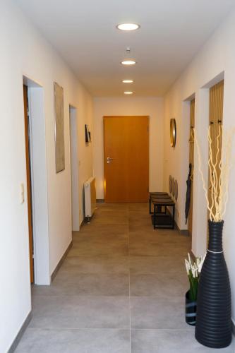 a hallway with a vase with flowers in it at Landliebe Nummer 10 in Braubach