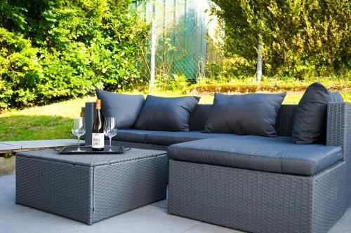 a patio with two couches and a table with wine glasses at Landliebe Nummer 10 in Braubach