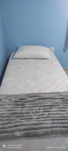 a close up of a bed with a pillow on it at casa do tidi in Rondônia