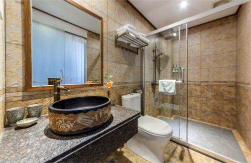 a bathroom with a large bath tub next to a toilet at Castle peak yard Inn Free railway st ation pick-up by 2 nights English and Spanish reception available in Guilin