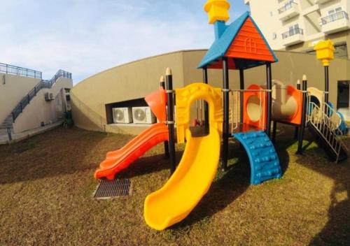 a playground with a slide in a yard at Luxury fairway living-Galle apartments in Galle