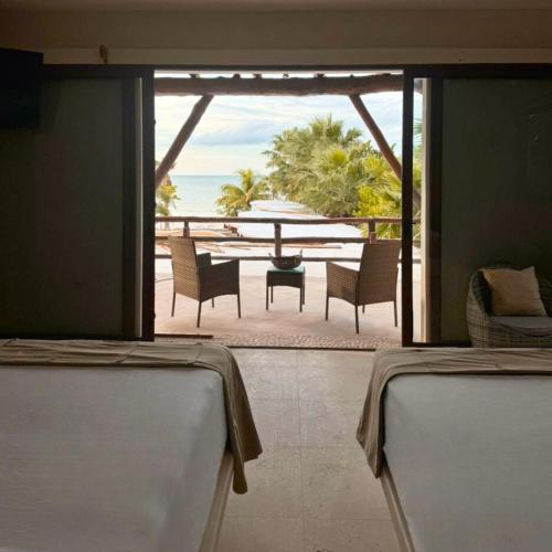 a view of a patio with a table and chairs at DK Luxury Ocean Front Villa - Adults Only in Holbox Island