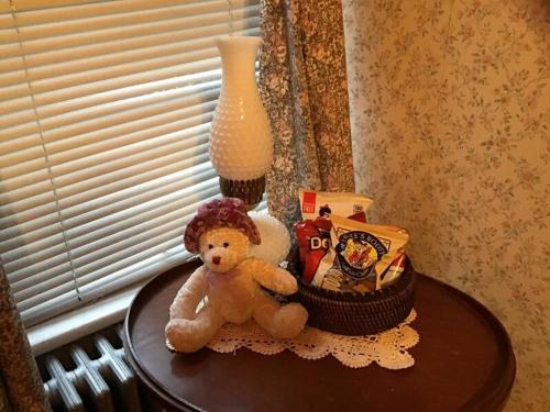 a stuffed teddy bear sitting on a table at Brookview Manor Inn in Canadensis