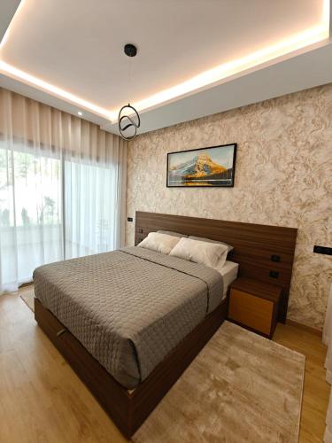 a bedroom with a large bed in a room at Appart Moderne Vue mer latérale & piscine - Plage des Sablettes El Mansouria in Ben Slimane
