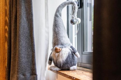a cat is standing on a window sill at Chalet Ortles Apt ll in San Valentino alla Muta