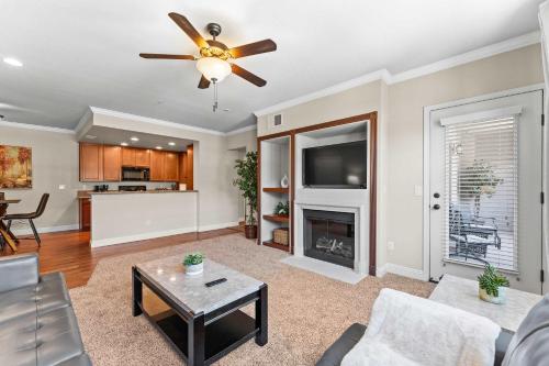 a living room with a ceiling fan and a fireplace at New Cozy 1BR Apt with Gym Sauna & Heated Pool Access in Reno