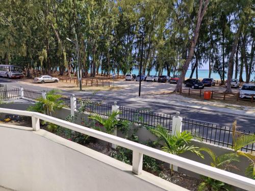 a white fence next to a parking lot at Pearl villa in Flic-en-Flac