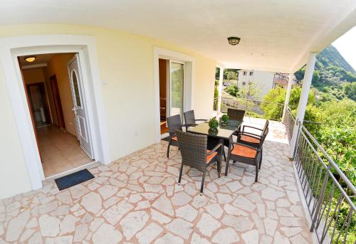 a patio with a table and chairs on a balcony at Apartments Soso in Kotor