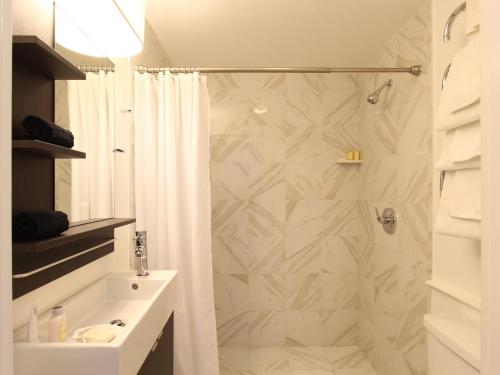 a bathroom with a shower and a sink at Charles and Charles MV in Vineyard Haven
