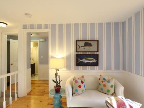 a living room with a white couch and striped walls at Charles and Charles MV in Vineyard Haven