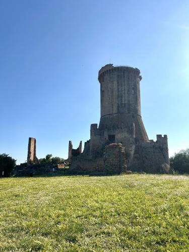an old castle sitting on a field of grass at La Casa di Nina in Castelnuovo Cilento