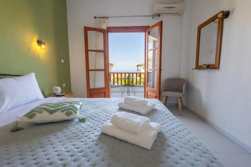 a bedroom with a bed with two towels on it at Horizon Studios Afitos in Afitos