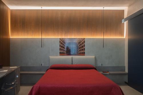 a bedroom with a bed with a red blanket at Zen escape Sicilia in San Gregorio di Catania